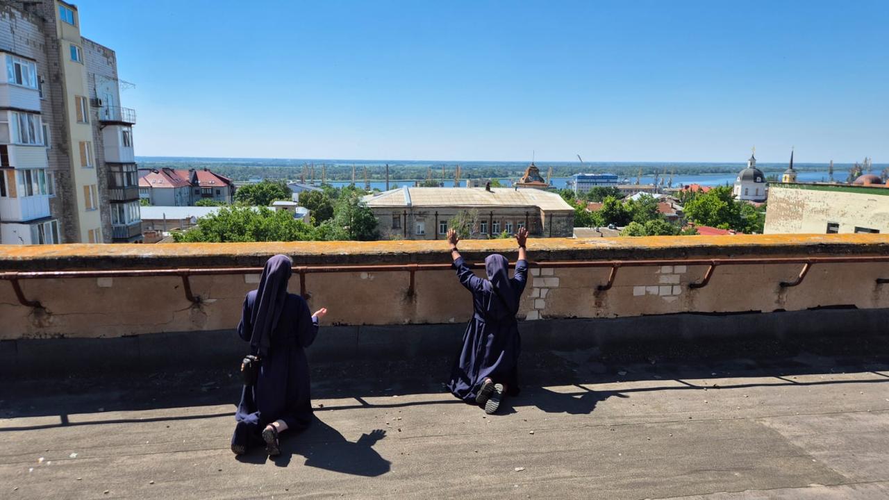 Sisters Praying on Rooftop